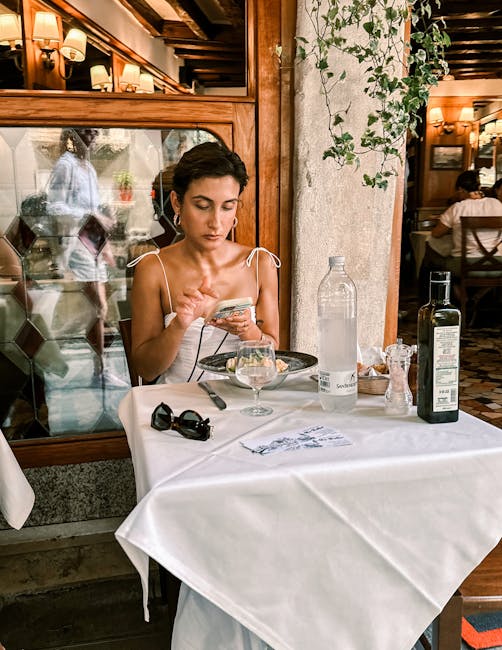 Woman dining and using mobile phone